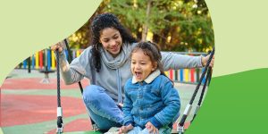 Teen playing with their younger sibling at a playground